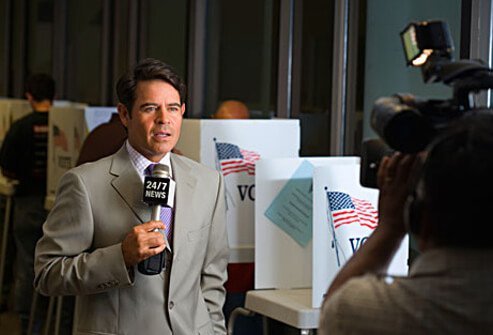Photo of a cable news reporter at a polling station.