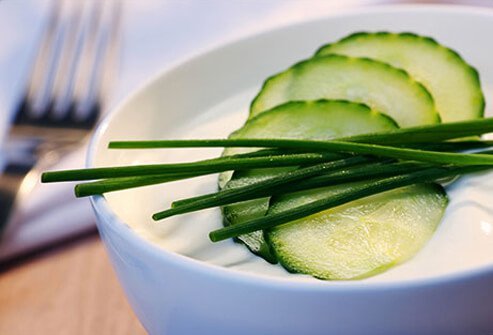 Photo of a bowl of yogurt and cucumbers.