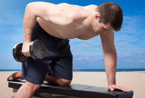 The dumbbell row works your lats as well as the rhomboid muscles in your upper back.