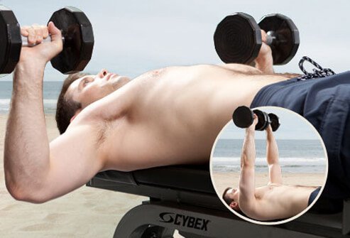 Photo of man doing bench press.