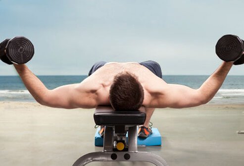 Lie on your back with a dumbbell in each hand.