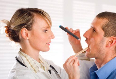 A doctor examines a patient's throat for signs of mono.