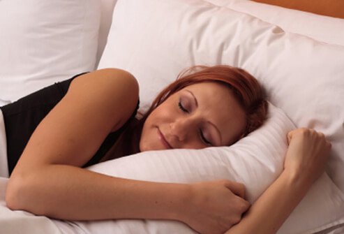 A woman sleeps as she recovers from mono.