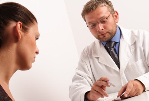 A doctor consults with a patient.