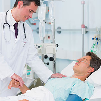 A doctor consults with a MRSA patient in the hospital.