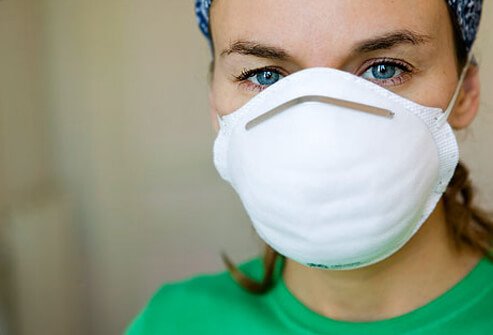 A woman wearing a dust mask.