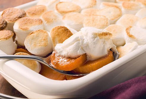 Sweet potato casserole topped with marshmallows.