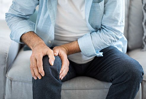 Joint pain and stiffness, such as in the knee, are symptoms of osteoarthritis.