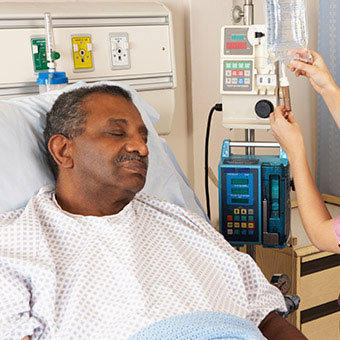 A nurse checking a patient's IV bag.