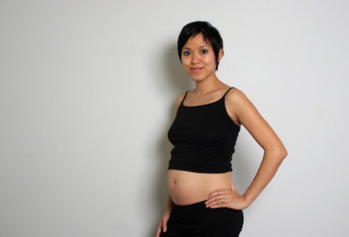 A pregnant woman starting to show.
