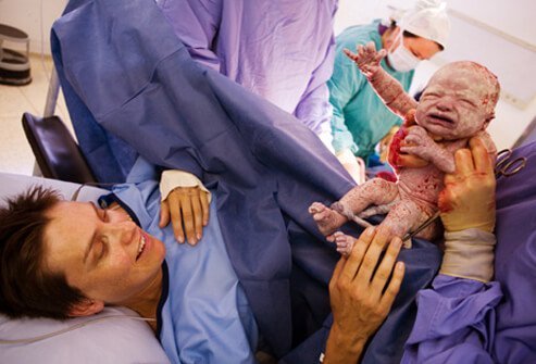 A mom looks at her newborn child.