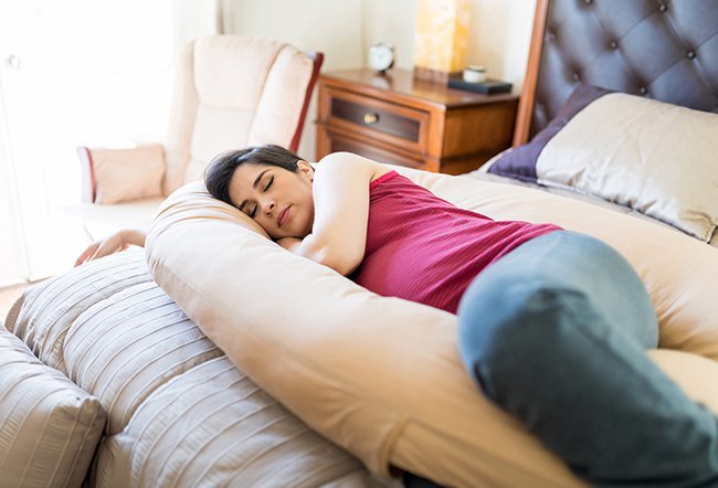 Hemorrhoids happen when pressure causes veins in your rectum and anus to stretch, swell, and bulge. Sleep with hemorrhoids by pushing them back in, taking a sitz bath before bed, using topical creams and using other strategies.  