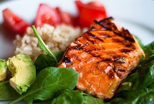 Cooked salmon on a full dinner plate.