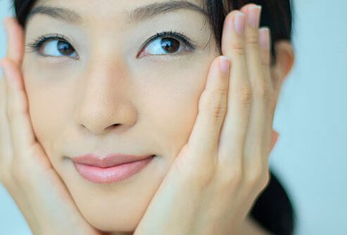 Photo of woman with face in hands.