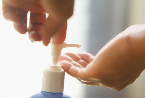 Photo of hands pumping lotion.