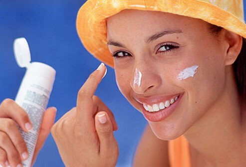 Photo of woman applying sunscreen.