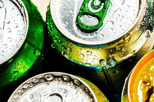 If you are concerned about what is on the top of a can you can wash it with soap and water prior to opening it.