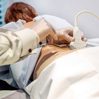A patient receives a cortisone shot for her sacroiliac (SI) joint pain.