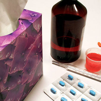 Decongestant medications and a tissue box.