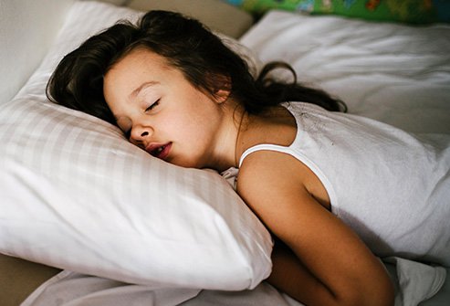People who sleep this way have their arms wrapped around a pillow.