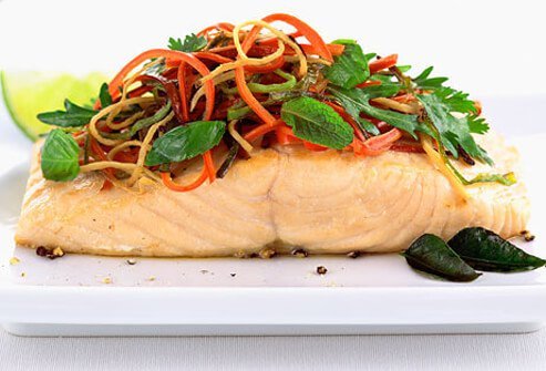 Salmon topped with leafy greens.