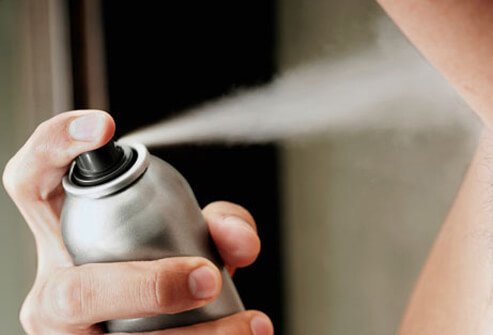 Photo of teen using deodorant.