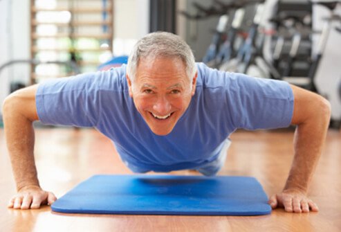 A man does push-ups in the gym.
