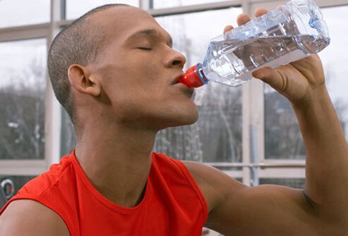 Photo of a man drinking water.