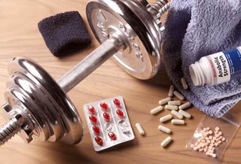 Photo of anabolic steroids, pills, and weights.