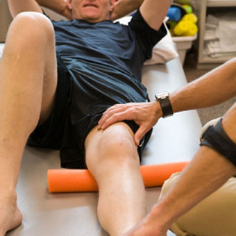 A man undergoes rehabilitation exercises for his knee.