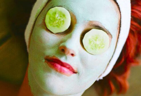 Photo of woman wearing cucumber mask.