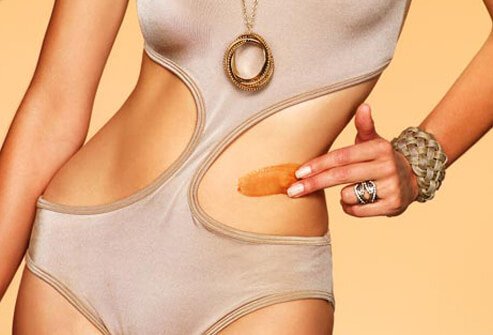 Photo of woman swimsuit bronze cream.