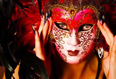Photo of woman wearing Venetian mask.