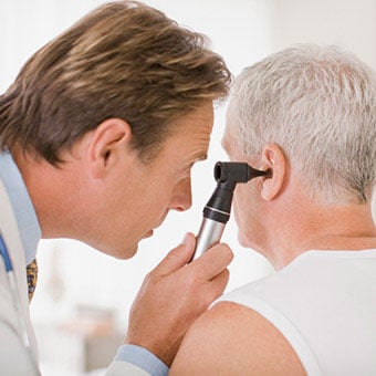 Does a doctor examine a patient's ear for infection?