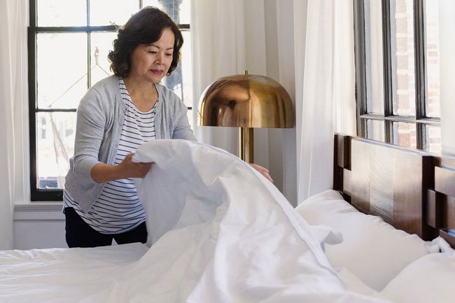 Choose bedding materials that will help you cooler at night including cotton, linen, latex, wool, or gel memory foam.
