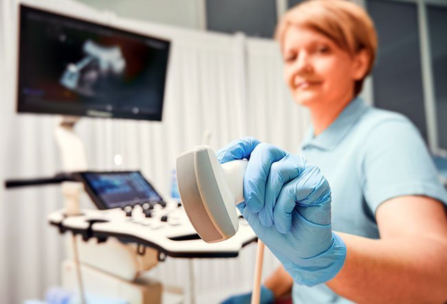 Ultrasound devices send ultrasonic soundwaves through tissue. The device measures how long the waves take to “echo” or return to the device, much like SONAR used by submarines. The programming in the device uses that data to assemble an image nearly in real time; different densities of tissue show up as different concentrations of lighted pixels on the screen, allowing doctors to map the internal structure of the organ or tissue.