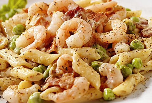 A plate of pasta with shrimp and chicken in carbonara can creep up to unhealthy levels.